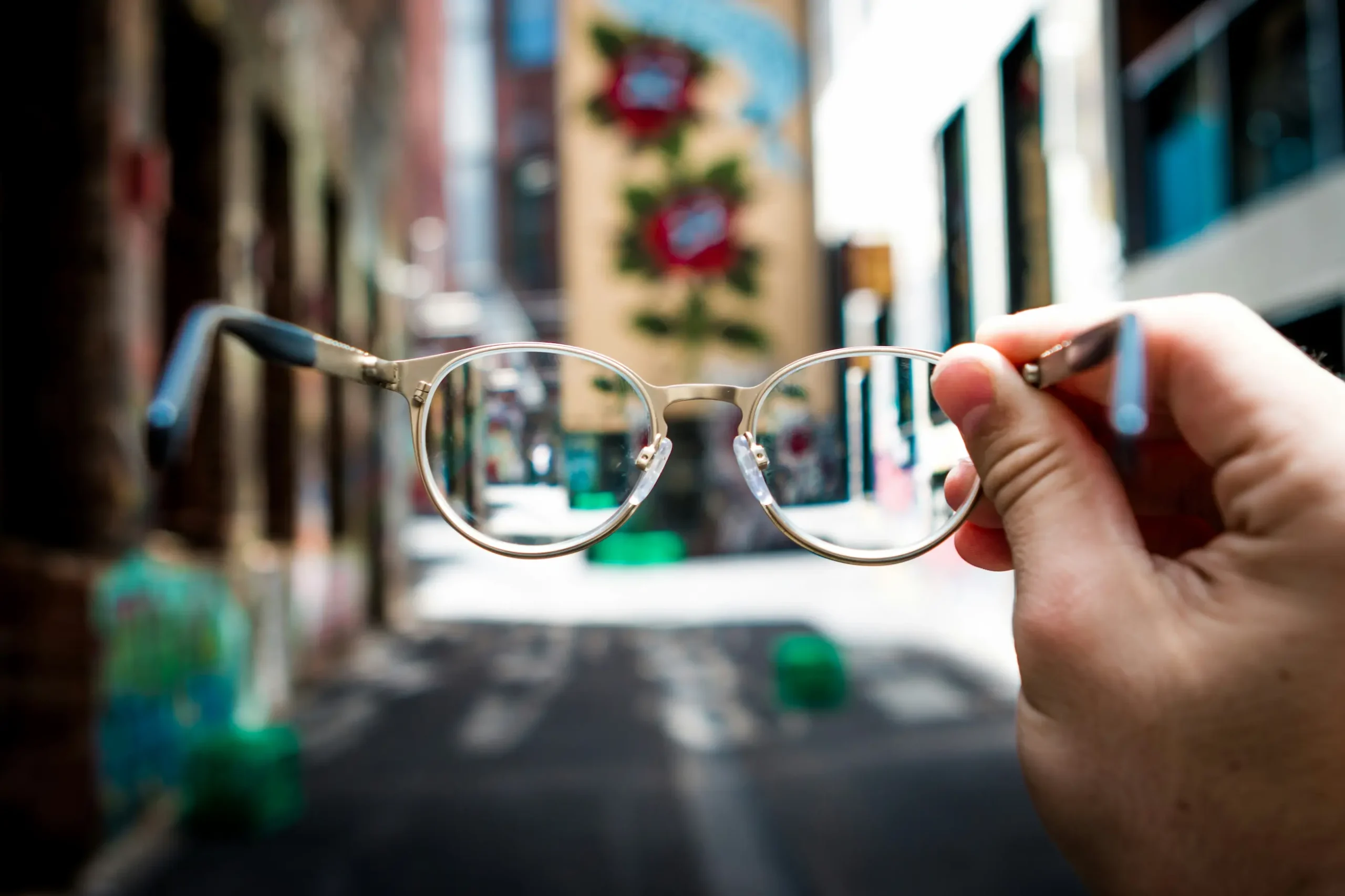 Photographie d'une paire de lunettes progressives devant un immeuble